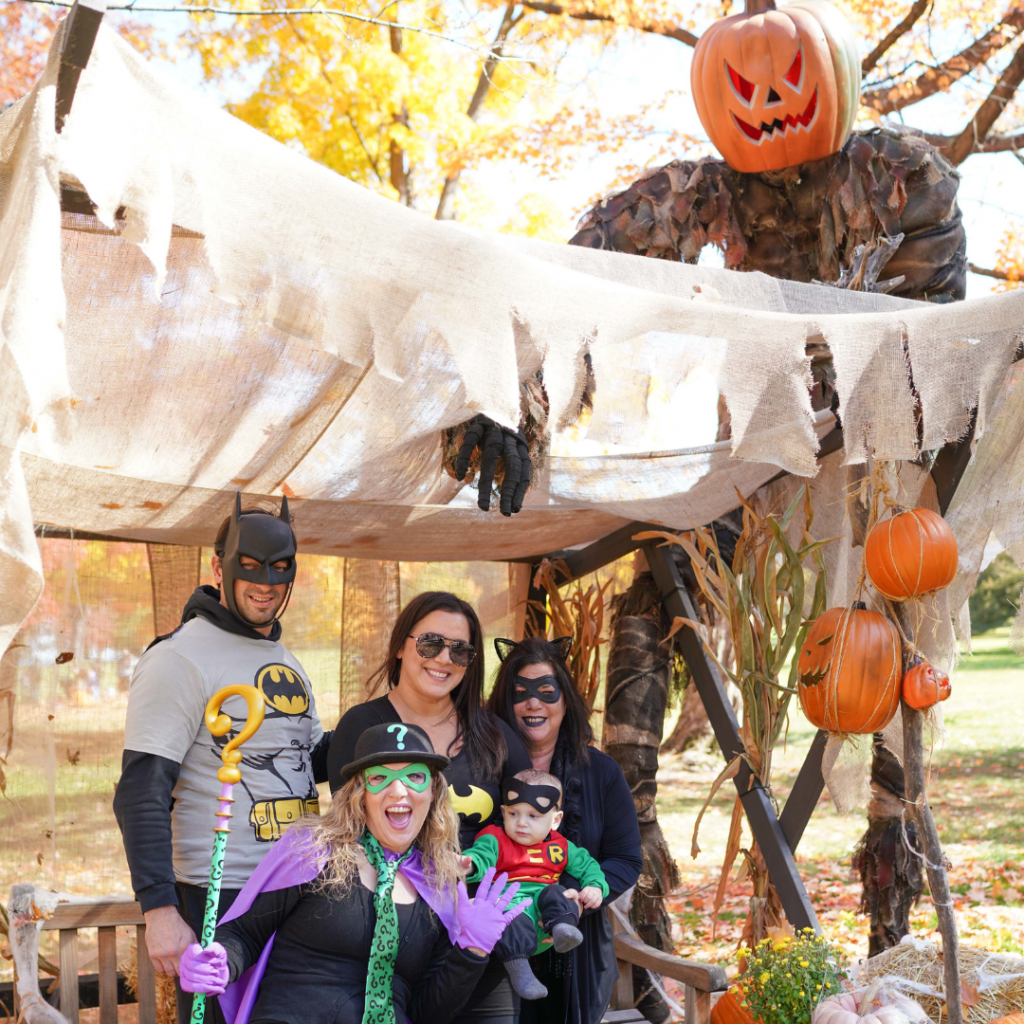 A family takes their picture under the Pumpkin King.