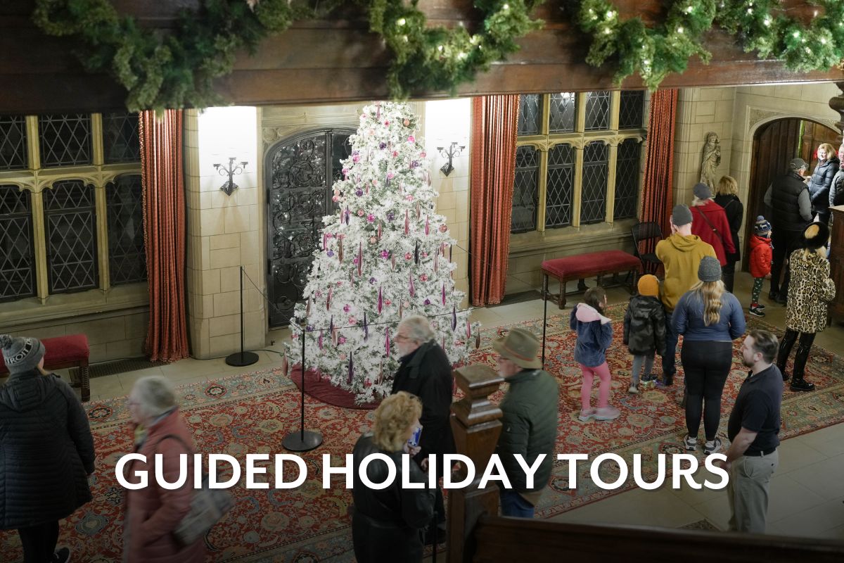 Visitors walking through the main hall at Ford House.